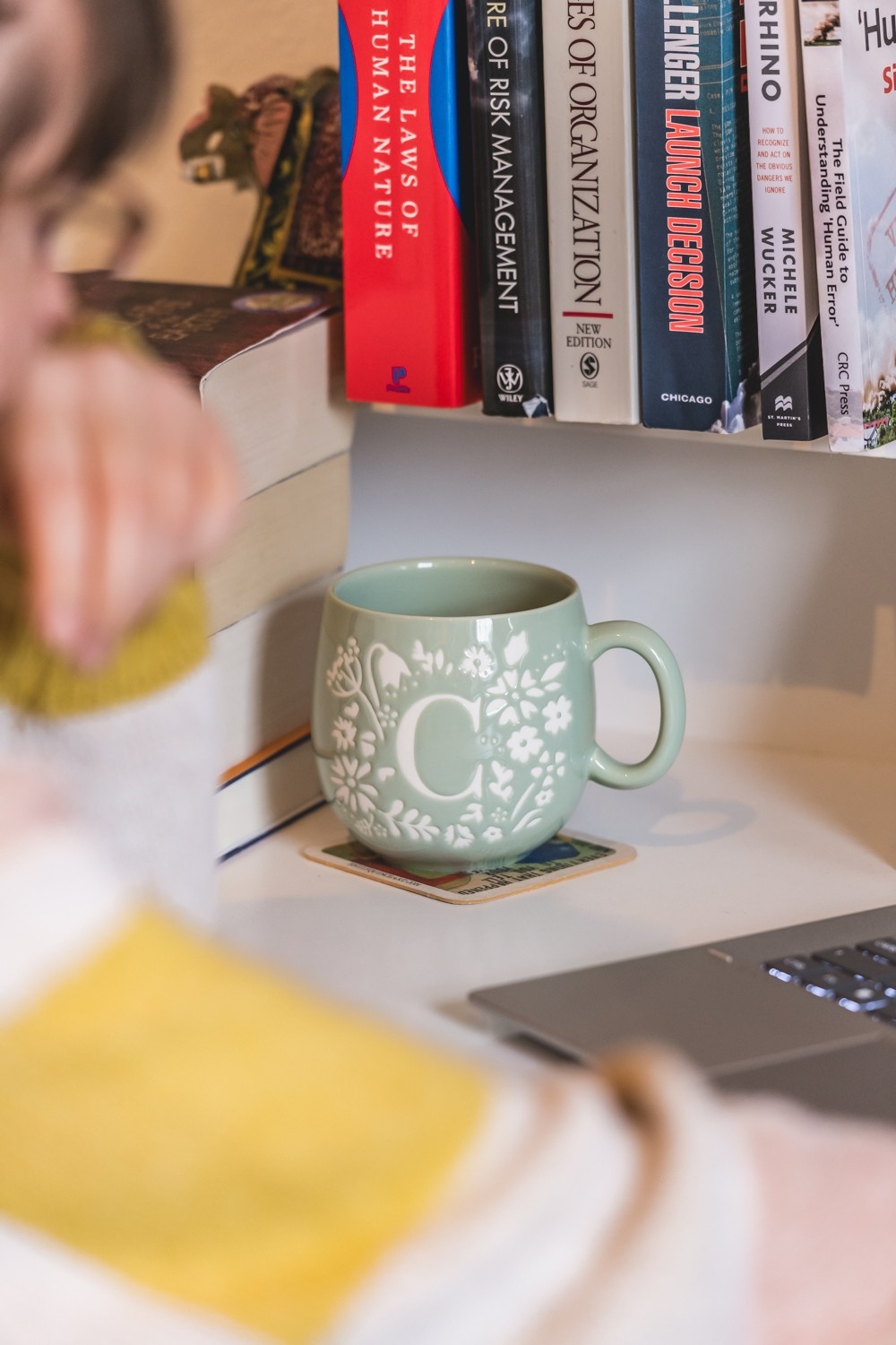 Green floral mug on desk