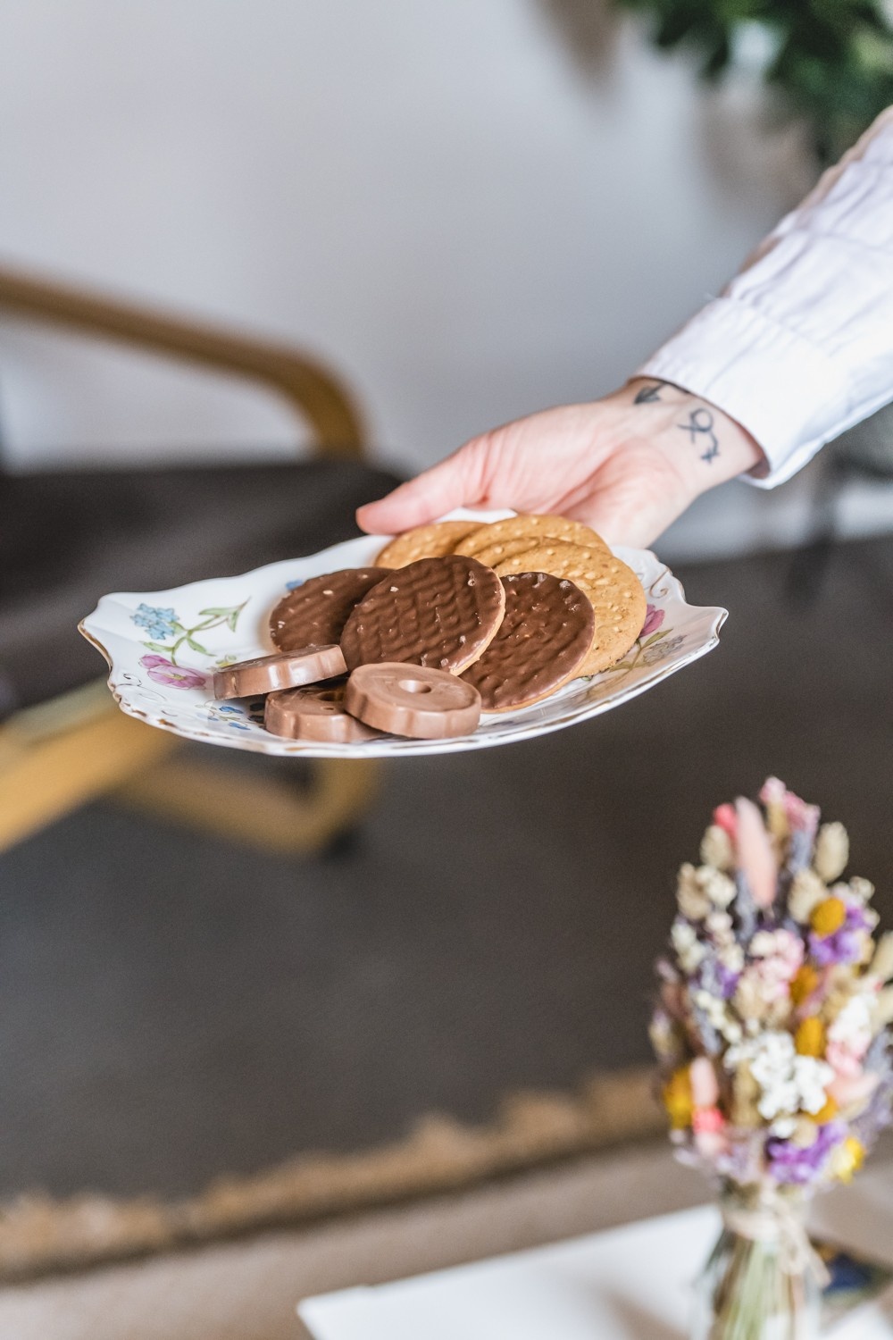 Hand holding cookies on plate